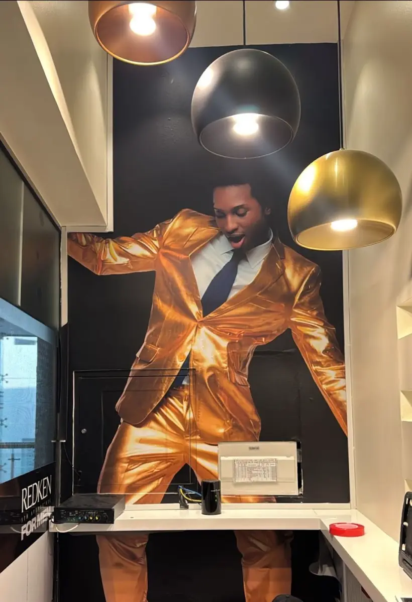 The gold mural wall at Stardust Gents Salon