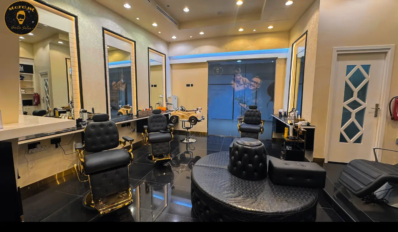 Inside Stardust Gents Salon: black chairs, gold trim and mirrors